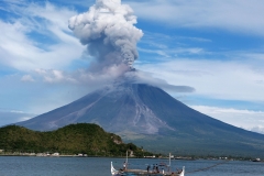jan-25-2018-a-fishing-boat-sails-as-mayon-volcano-erupts-in-news-photo-910658126-1548290308-scaled